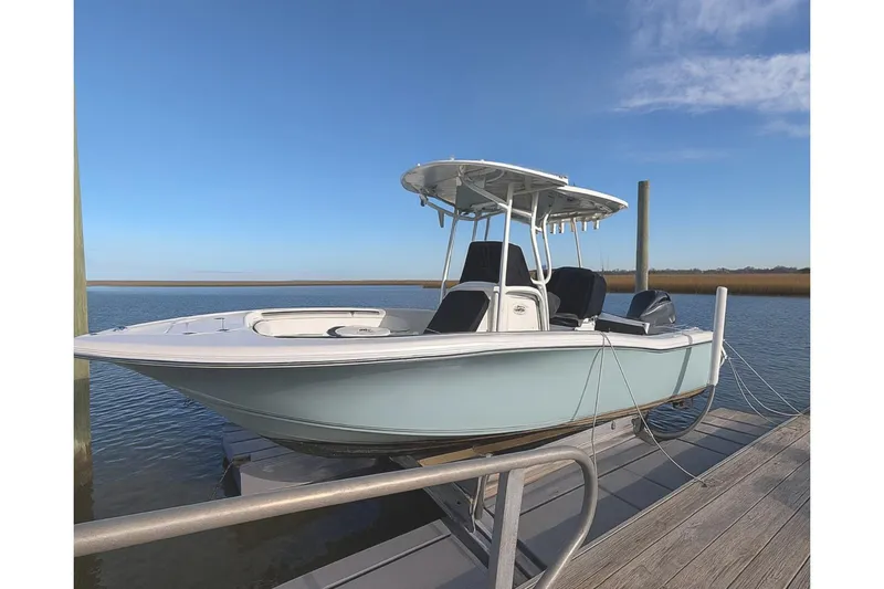 The Image of 2022 Tidewater 220 LXF boat docked on a sunny day, showcasing sleek design. - 0