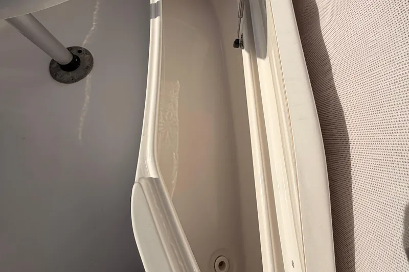 Slide: The Image of 2022 Tidewater 220 LXF boat interior with seating and engine view. - 14