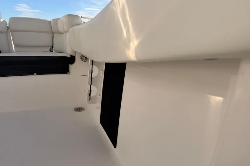 Slide: The Image of 2022 Tidewater 220 LXF boat interior with Yamaha 200 engine, docked by water. - 16