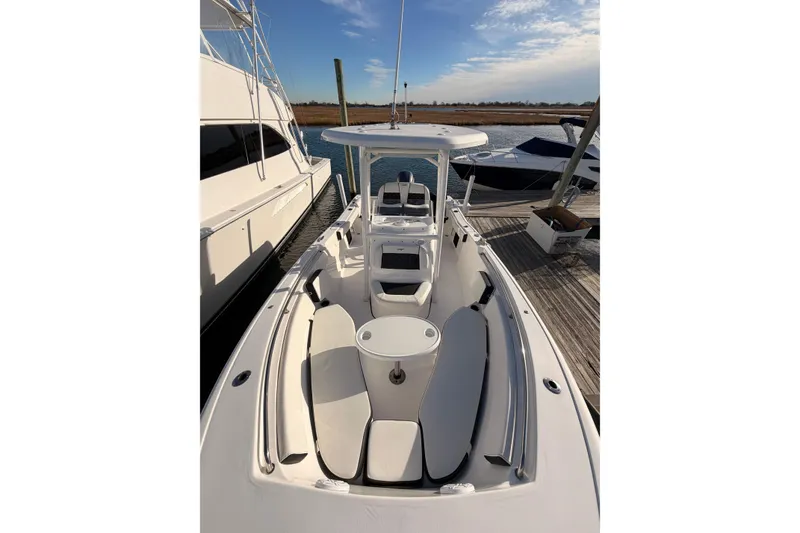 Slide: The Image of 2022 Tidewater 220 LXF boat docked near a waterfront building. - 4