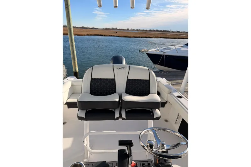 Slide: The Image of 2022 Tidewater 220 LXF boat dashboard with steering wheel and controls. - 7