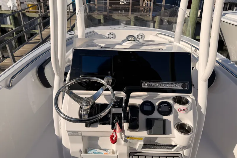 Slide: The Image of 2022 Tidewater 220 LXF boat console with electronics and storage compartment. - 8