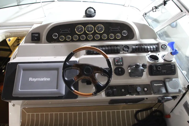 Slide: The Image of 2003 Cruisers Yachts 4450 Express Motoryacht helm with Raymarine navigation system. - 13
