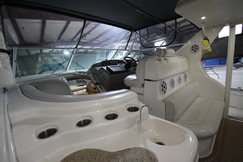 Slide: The Image of 2003 Cruisers Yachts 4450 Express Motoryacht interior with helm, seating, and sink area. - 15