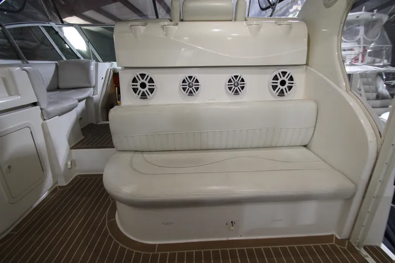 Slide: The Image of 2003 Cruisers Yachts 4450 Express Motoryacht interior with white seating and speaker system. - 16
