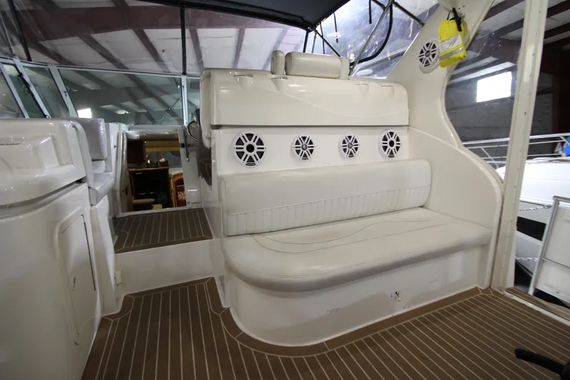 Slide: The Image of 2003 Cruisers Yachts 4450 Express Motoryacht interior with white seating and speakers. - 17