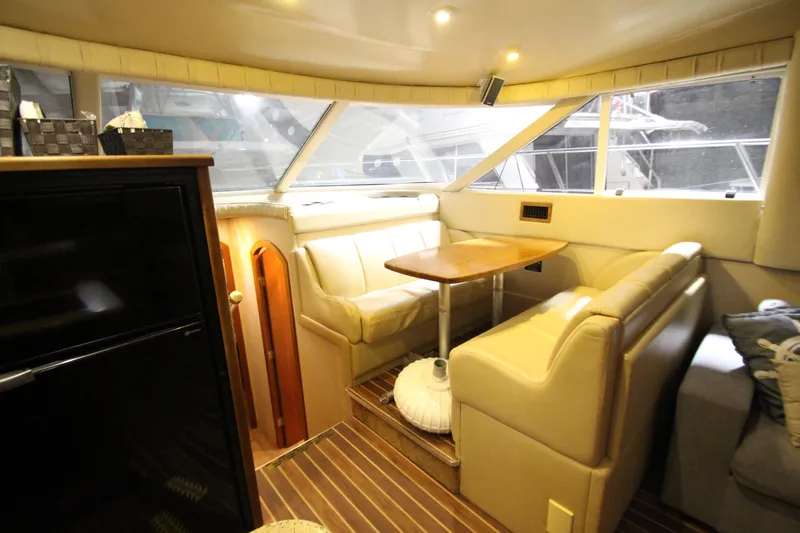 Slide: The Image of Luxurious interior of 2003 Cruisers Yachts 4450 Express Motoryacht with elegant seating and table. - 28