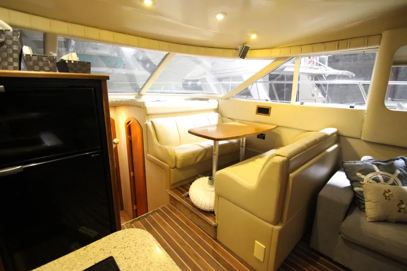 Slide: The Image of Luxurious interior of 2003 Cruisers Yachts 4450 Express Motoryacht with plush seating and dining area. - 29