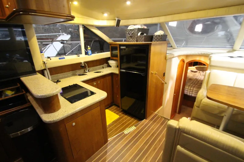 Slide: The Image of Luxurious 2003 Cruisers Yachts 4450 Express Motoryacht interior with modern kitchen and cozy seating. - 31