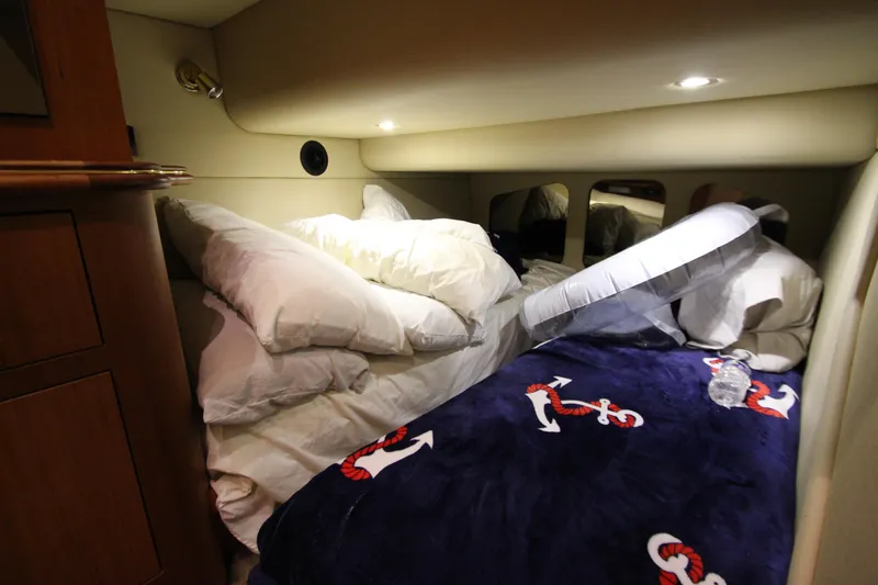 Slide: The Image of Cozy cabin interior of 2003 Cruisers Yachts 4450 Express Motoryacht with nautical-themed bedding. - 38