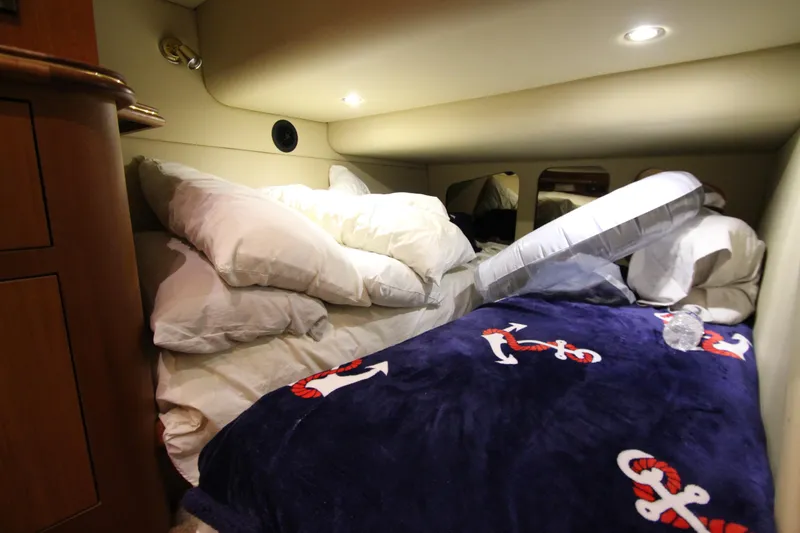 Slide: The Image of Cozy cabin interior of 2003 Cruisers Yachts 4450 Express Motoryacht with nautical-themed bedding. - 39