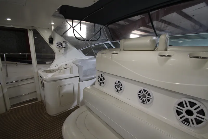 Slide: The Image of 2003 Cruisers Yachts 4450 Express Motoryacht interior with seating and speakers. - 4