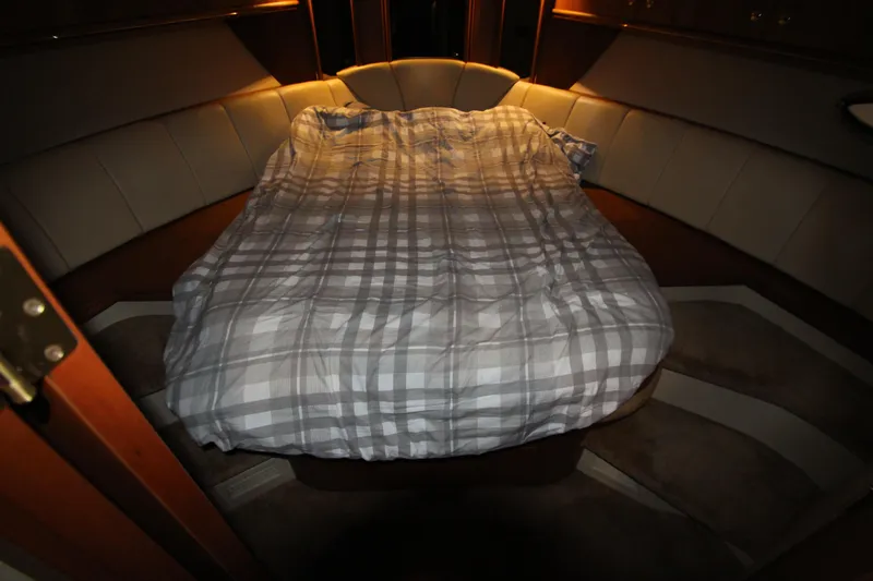 Slide: The Image of 2003 Cruisers Yachts 4450 Express Motoryacht cabin with cozy bed and ambient lighting. - 42