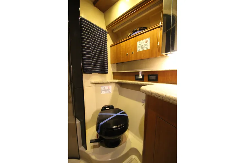 Slide: The Image of 2003 Cruisers Yachts 4450 Express Motoryacht bathroom with modern fixtures and wood cabinetry. - 49