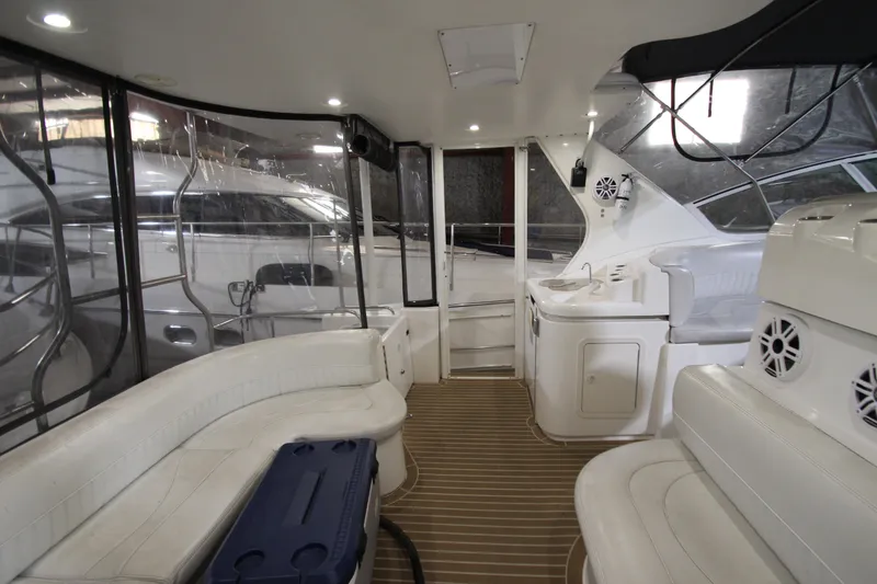 Slide: The Image of 2003 Cruisers Yachts 4450 Express Motoryacht interior with white seating and wood flooring. - 5