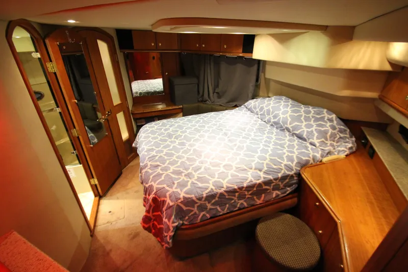 Slide: The Image of Luxurious bedroom interior of 2003 Cruisers Yachts 4450 Express Motoryacht with elegant wood finishes. - 52