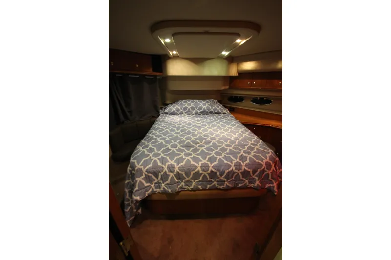 Slide: The Image of Luxurious bedroom interior of 2003 Cruisers Yachts 4450 Express Motoryacht with patterned bedding. - 60