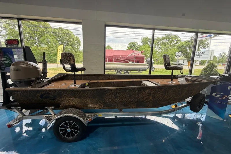 Slide: The Image of 2026 G3 Gator Tough Package Jon 17 DK boat on display in showroom. - 10