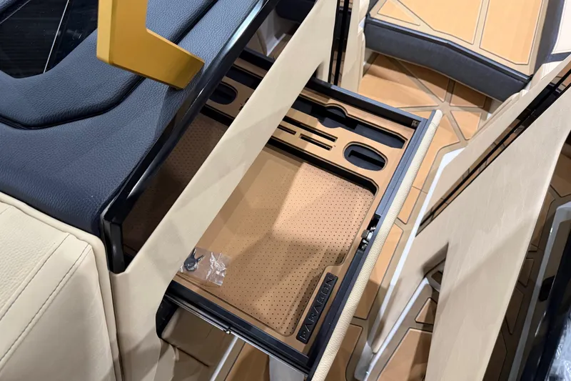 Slide: The Image of 2026 Nautique Super Air Nautique G25 Paragon interior with open storage compartment. - 11