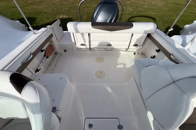 Slide: The Image of 2021 Robalo R227 Dual Console boat interior with seating and steering console. - 13
