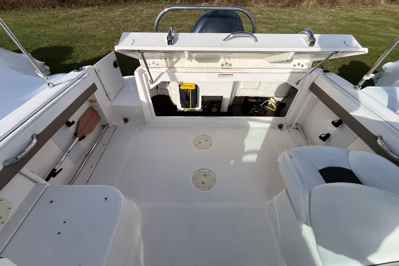 Slide: The Image of 2021 Robalo R227 Dual Console boat interior with white seating and spacious deck. - 14