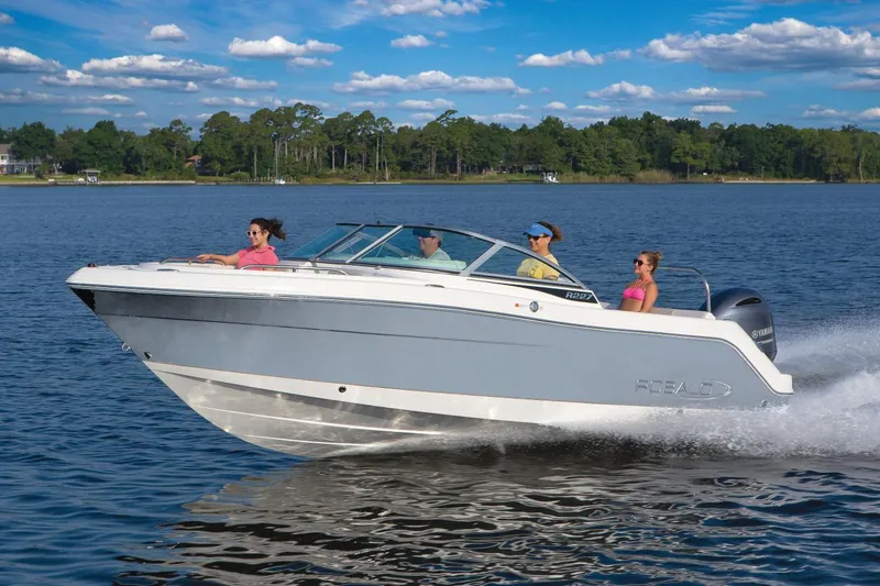Slide: The Image of 2021 Robalo R227 Dual Console boat interior with seating and steering console. - 2