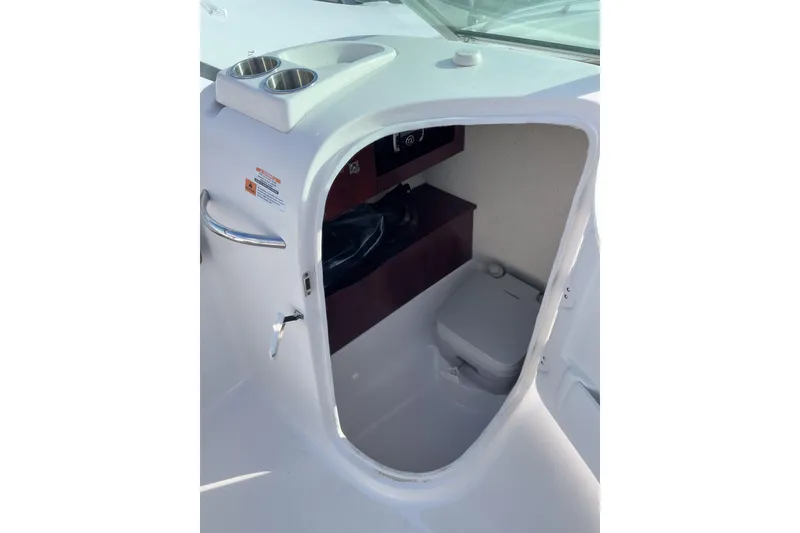 Slide: The Image of 2021 Robalo R227 Dual Console boat helm with steering wheel and control panel. - 7