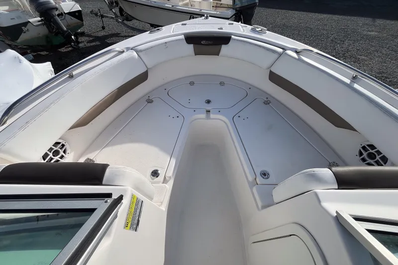 Slide: The Image of 2021 Robalo R227 Dual Console boat interior with compact marine toilet. - 8