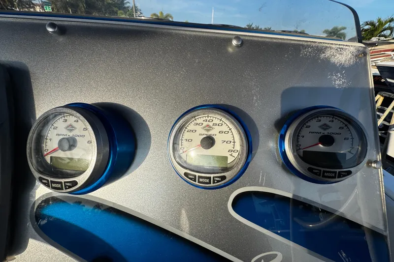 Slide: The Image of Dashboard of a 2012 Renegade 32 CC boat with RPM and speed gauges. - 10