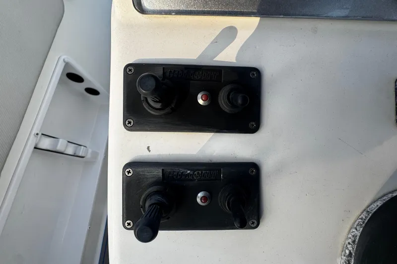 Slide: The Image of Control panel of a 2012 Renegade 32 CC boat with dual switches. - 16