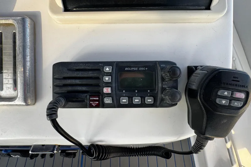 Slide: The Image of VHF radio equipment on 2012 Renegade 32 CC boat dashboard. - 18