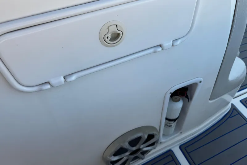 Slide: The Image of 2012 Renegade 32 CC boat interior with storage compartment and speaker. - 24