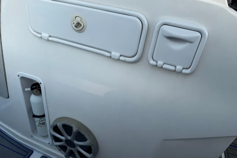 Slide: The Image of 2012 Renegade 32 CC boat interior with storage compartments and fire extinguisher. - 25