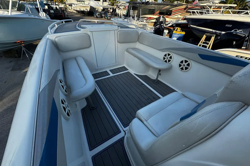 Slide: The Image of 2012 Renegade 32 CC boat interior with cushioned seating and marine speakers. - 26