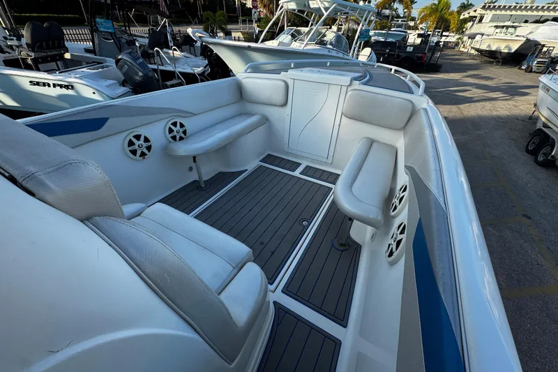 Slide: The Image of 2012 Renegade 32 CC boat interior with seating and speakers, docked at marina. - 27
