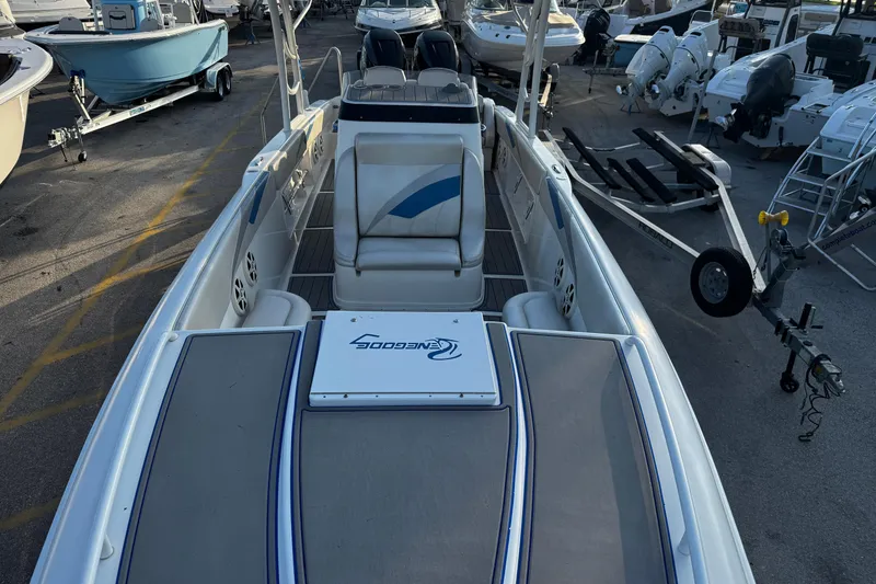 Slide: The Image of 2012 Renegade 32 CC boat in marina, showcasing spacious deck and seating. - 29