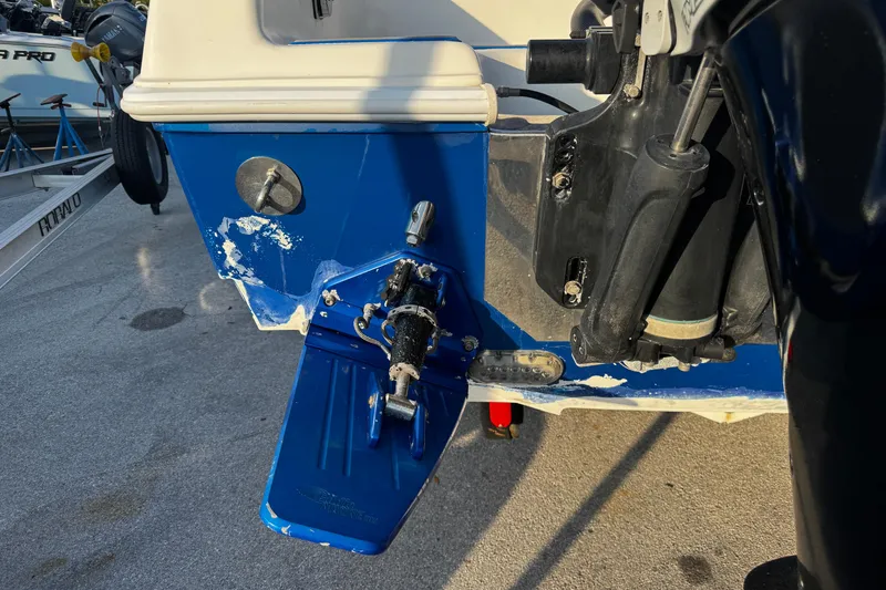 Slide: The Image of Close-up of a 2012 Renegade 32 CC boat's blue trim tab and hydraulic system. - 36