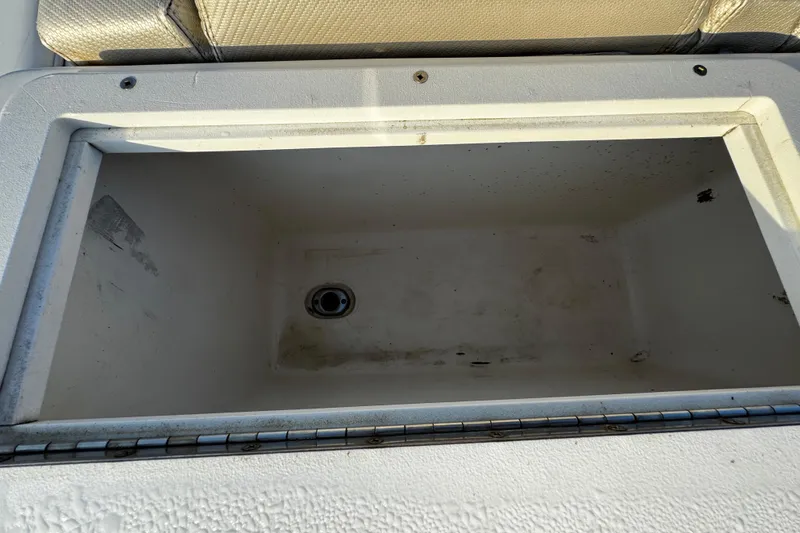 Slide: The Image of Open storage compartment on 2012 Renegade 32 CC boat, showing interior details. - 38