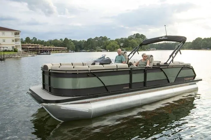 Slide: The Image of 2026 Veranda RELAX VR235VLI pontoon boat on a serene lake with two passengers. - 10