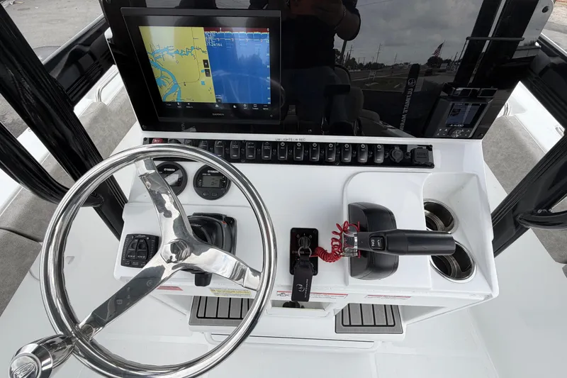 Slide: The Image of 2025 Sea Hunt Ultra 219 boat interior with steering console and seating. - 15