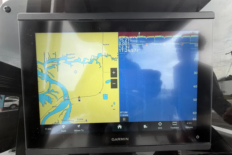 Slide: The Image of 2025 Sea Hunt Ultra 219 boat dashboard with steering wheel and navigation equipment. - 16