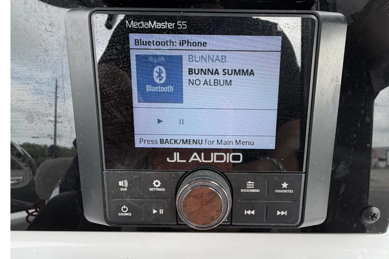 Slide: The Image of 2025 Sea Hunt Ultra 219 boat dashboard with steering wheel and navigation display. - 17