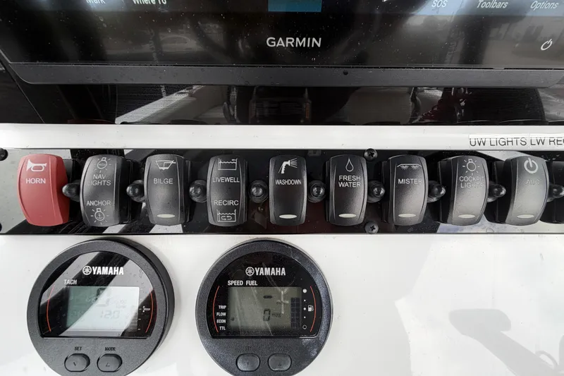 Slide: The Image of Garmin navigation display on 2025 Sea Hunt Ultra 219 boat dashboard, showing map and controls. - 18