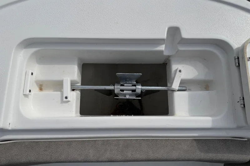 Slide: The Image of 2025 Sea Hunt Ultra 219 boat console with blue LED lights and storage compartment. - 29