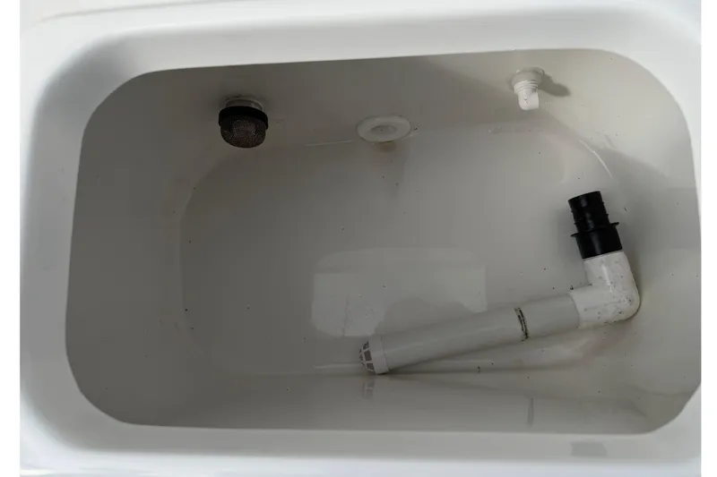 Slide: The Image of 2025 Sea Hunt Ultra 219 boat interior with open console door and steering wheel. - 32