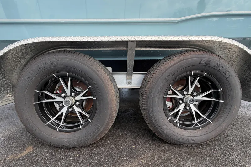 Slide: The Image of 2025 Sea Hunt Ultra 219 boat cabin entrance with open door, showcasing interior space. - 33