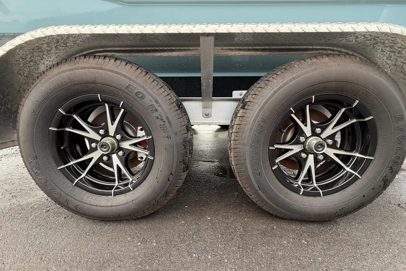 Slide: The Image of 2025 Sea Hunt Ultra 219 boat interior with cushioned seating and speakers. - 35