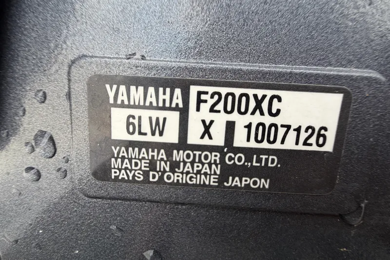 Slide: The Image of Bow seating area of 2025 Sea Hunt Ultra 219 boat, featuring cushioned seats and storage. - 38