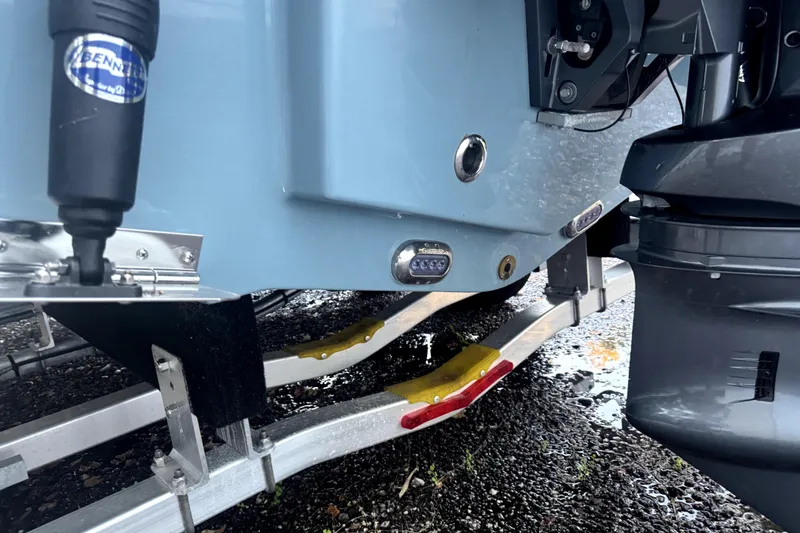 Slide: The Image of 2025 Sea Hunt Ultra 219 boat on trailer under bright sun at dealership. - 4