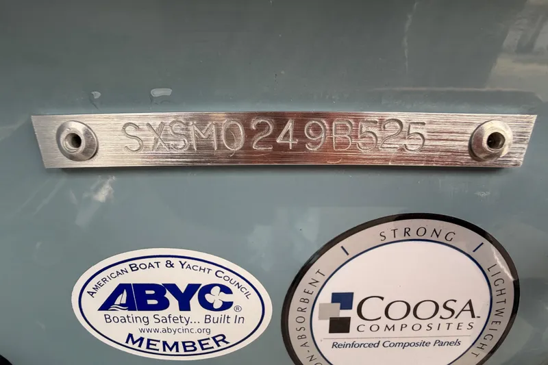 Slide: The Image of 2025 Sea Hunt Ultra 219 boat anchor compartment with gray interior. - 40